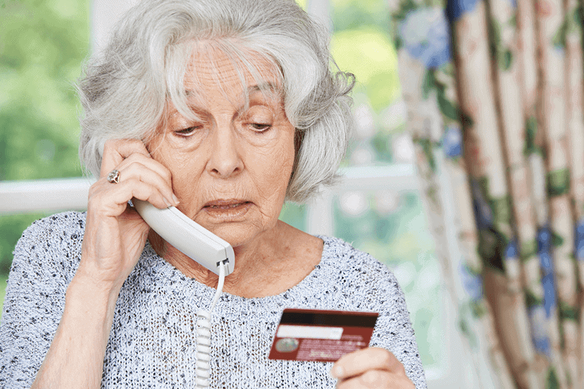 A picture of a lady on the phone taking a fraudulent call