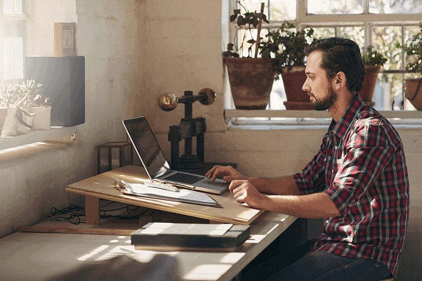 Image of an accountant working at their laptop